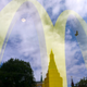 The Kremlin's towers can be seen reflected in a window along with a yellow McDonald's sign.